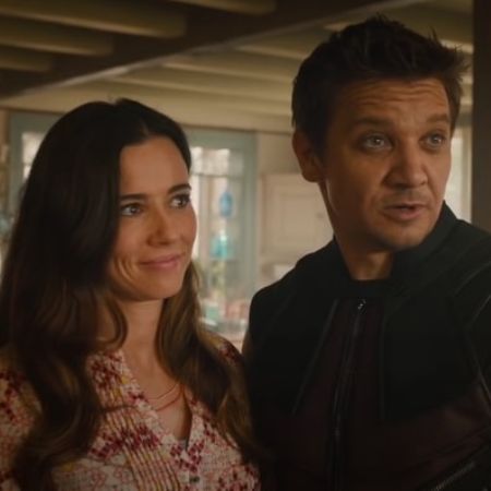 Linda Cardellini is standing next to Hawkeye in the picture.